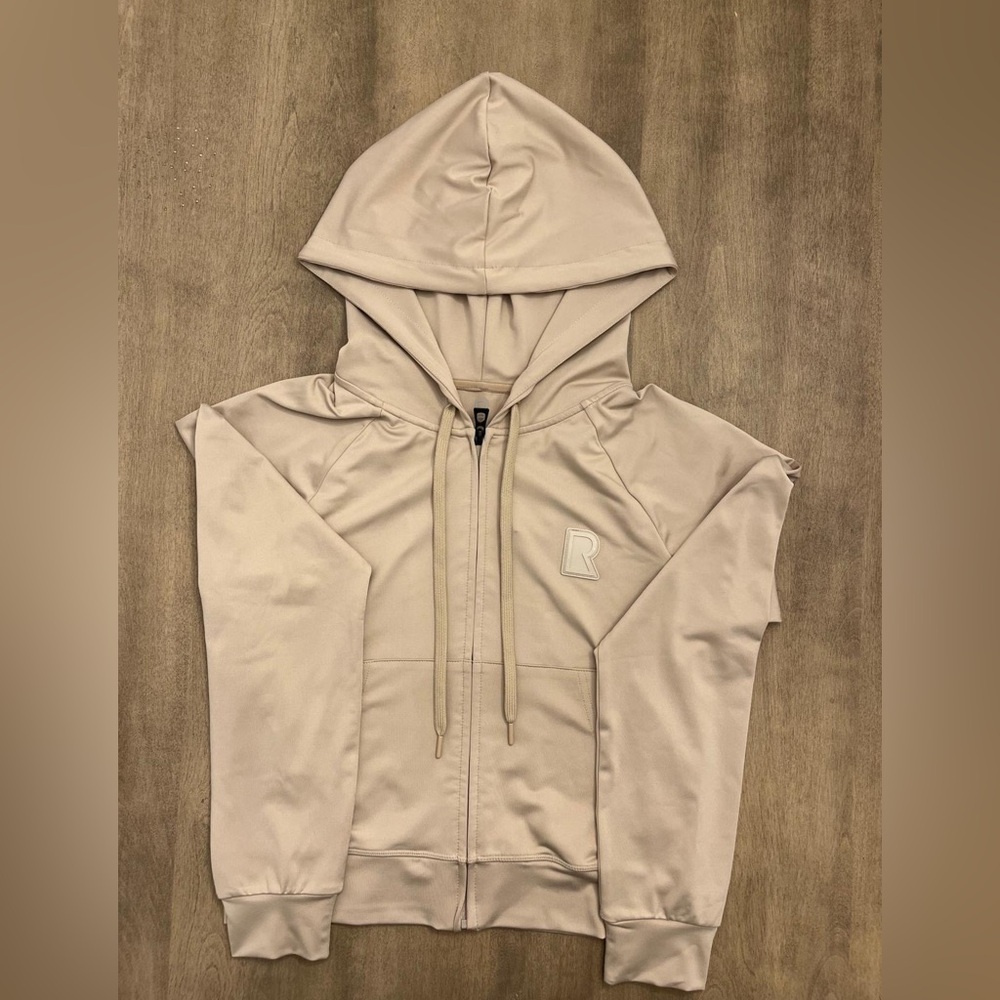 Woman’s stylish tan Rudsak hoodie, size medium, brand new with tags.